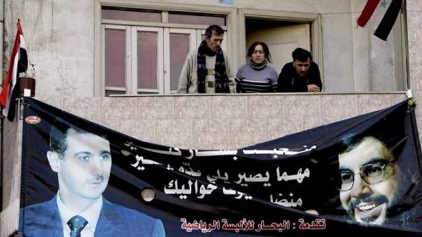A-banner-of-Bashar-al-Assad-left-and-Leb