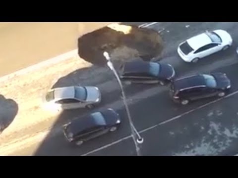 Youtube: Earth collapses in middle of  highway in Russia | Sinkhole Opens Up on Road in Russia