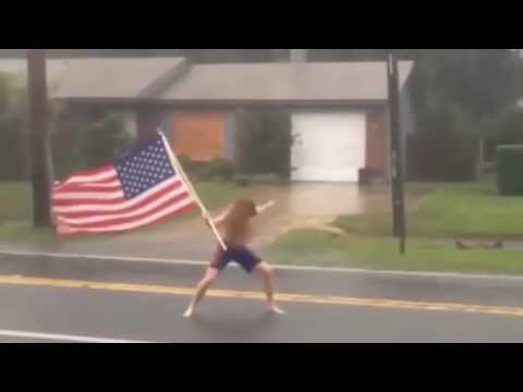 Youtube: Florida crazy man challenges hurricane Matthew with American flag in hand.