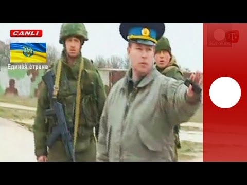 Youtube: Video: Russian troops fire warning shots as Ukrainian military march towards Crimea air base